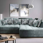 Tigalet corner sofa bed with electric seat adjustment in a modern living room setting