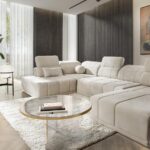 RAVELLO VI modern corner sofa with adjustable headrests in a contemporary living room.