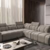 AVELIO IX corner sofa demonstrating an adjustable headrest in use.